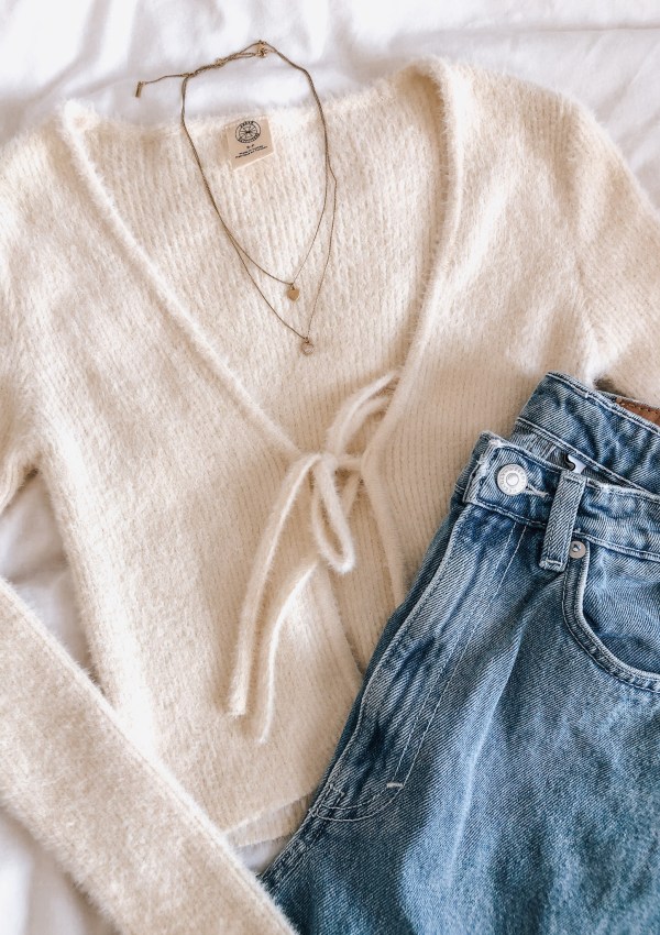 Tie front cropped cardigan and blue jeans.